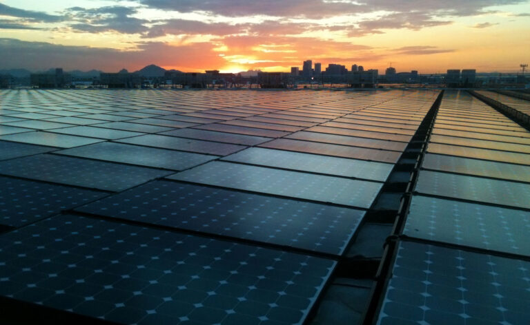 multi-megawatt solar panel installation on a commercial warehouse building in arizona